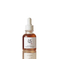 Skincare serum bottle with dropper on a light beige background
