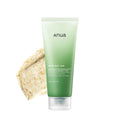 Green tube of anua product with a textured beige background